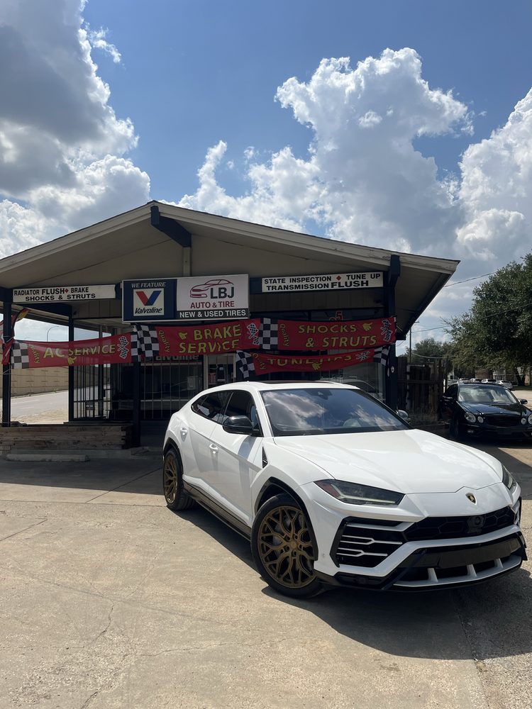 A Urus on the same lot as a work truck